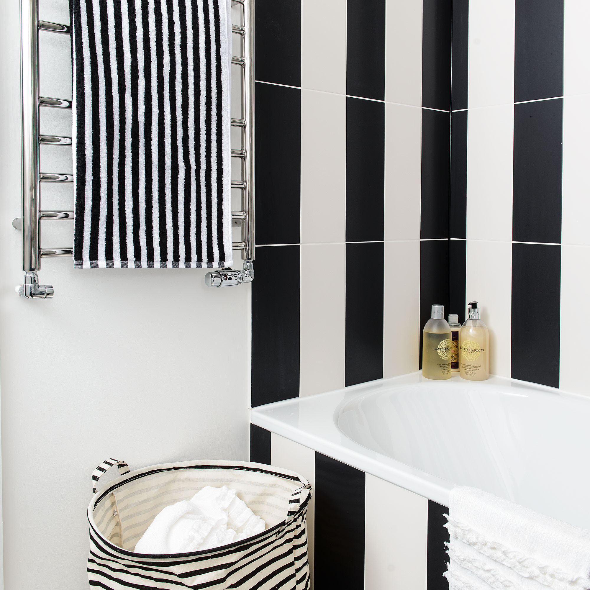 Kamar mandi dengan garis-garis ubin hitam dan putih vertikal